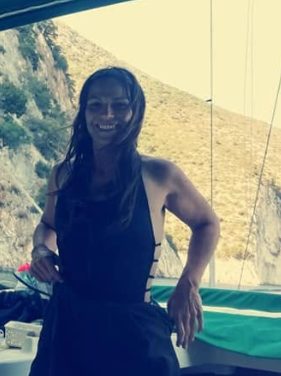 Afroditi Kazakou, Head of Marketing, Customer Experience and Innovation at AIyachts, at the helm of a sailing yacht